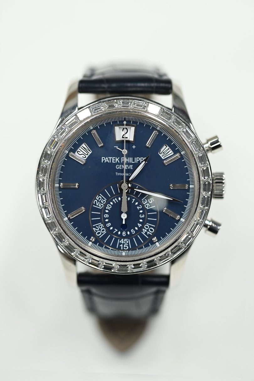 Patek Philippe annual calendar chronograph in white gold with blue dial signed Tiffany and Co, baguette diamond bezel and diamond markers